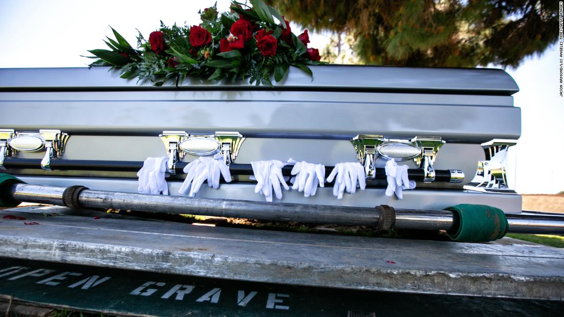 Gloves worn by pallbearers are draped on the casket of retired officer Charles Jackson Jr., who died from Covid-19 in April 2020 in Los Angeles. Covid restrictions prevented many people from saying goodbye to dying loved ones in person.