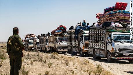 Families sit in trucks after their release from a camp holding relatives of suspected Islamic State  fighters in northeastern Syria.