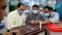 Iranian election officials prepare ballot boxes at a polling station in Tehran.