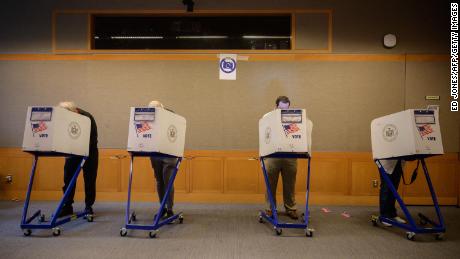 Voters stand in booths at a voting station at the Metropolitan Museum of Art (MET) during the mayoral election process in New York on June 12, 2021.