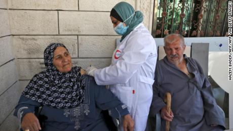 Elderly Palestinians are vaccinated against Covid-19 in the village of Dura near Hebron in the West Bank on June 9.