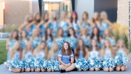 Morgyn Arnold, front row center, poses in a cheerleading portrait that was not used in her school&#39;s yearbook. CNN intentionally blurred the image due to the age of the other subjects in the image.
