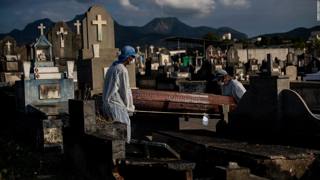 Workers at the Inhauma cemetery in Rio de Janeiro, Brazil, carry the coffin containing the remains of 89-year-old Irodina Pinto Ribeiro on Friday, June 18, 2021. Brazil has now marked 500,000 deaths from Covid-19 -- the second-highest death toll in the world. 