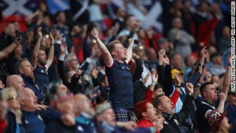 Scotland&#39;s supporters sing the national anthem before the start of the match against England.