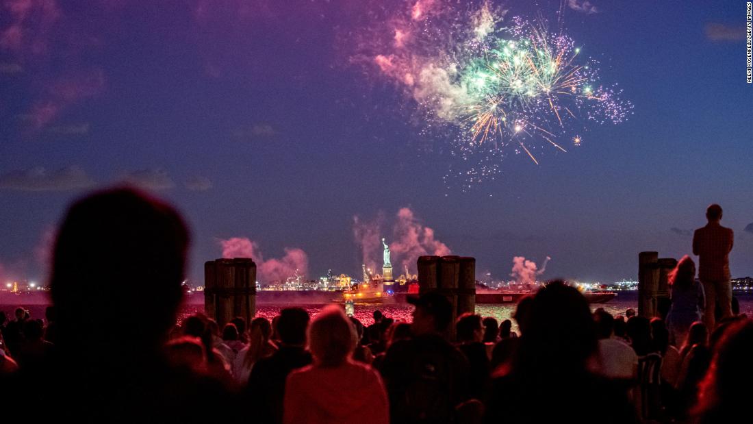 People watch fireworks in front of the Statue of Liberty after the state of New York lifted most of its Covid-19 restrictions on Tuesday, June 15. Gov. Andrew Cuomo announced that 70% of adults in New York had received at least one dose of a Covid-19 vaccine.