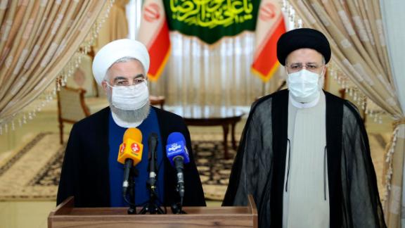 In this photo released by the official website of the office of the Iranian Presidency, President Hassan Rouhani, left, speaks with the media after his meeting with President-elect Ebrahim Raisi, right, who is current judiciary chief, in Tehran, Iran, Saturday, June 19, 2021. Iran's hard-line judiciary chief won the country's presidential election in a landslide victory Saturday, propelling the supreme leader's protege into Tehran's highest civilian position in a vote that appeared to see the lowest turnout in the Islamic Republic's history. (Iranian Presidency Office via AP)