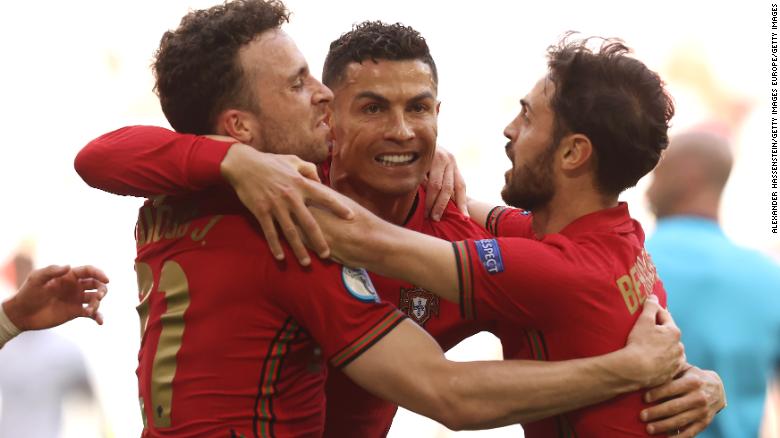 Ronaldo celebrates his goal with Jota (left) and Silva (right). 