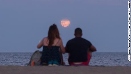Last year's strawberry moon is seen from Malaga, Spain.