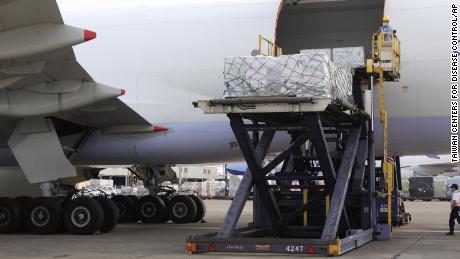 Workers unload Covid-19 vaccines from a cargo plane from Memphis in Taipei, Taiwan, on June 20.