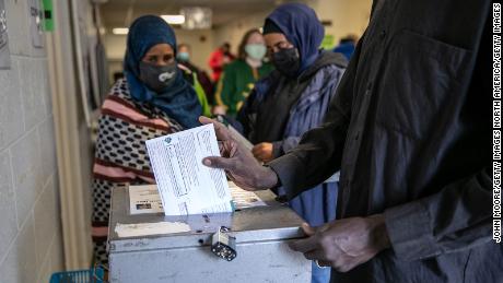 LANSING, MICHIGAN - NOVEMBER 02: Somali Americans cast their early votes at the Lansing City Clerk&#39;s office on November 02, 2020 in Lansing, Michigan. In 2016 U.S. President Donald Trump narrowly won Michigan, which is now a main battleground state. (Photo by John Moore/Getty Images)