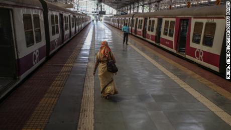 People walk along a platform at the Chhatrapati Shivaji Maharaj Terminus train station during a lockdown in Mumbai, India, on Tuesday, April 27, 2021. 