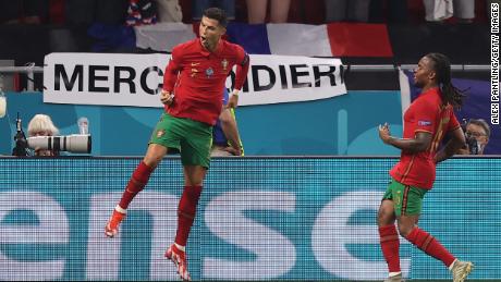 Ronaldo celebrates with teammate Renato Sanches after scoring his side&#39;s second goal against France.