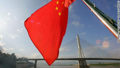 China&#39;s flag flies from a ship sailing down the Mekong River.
