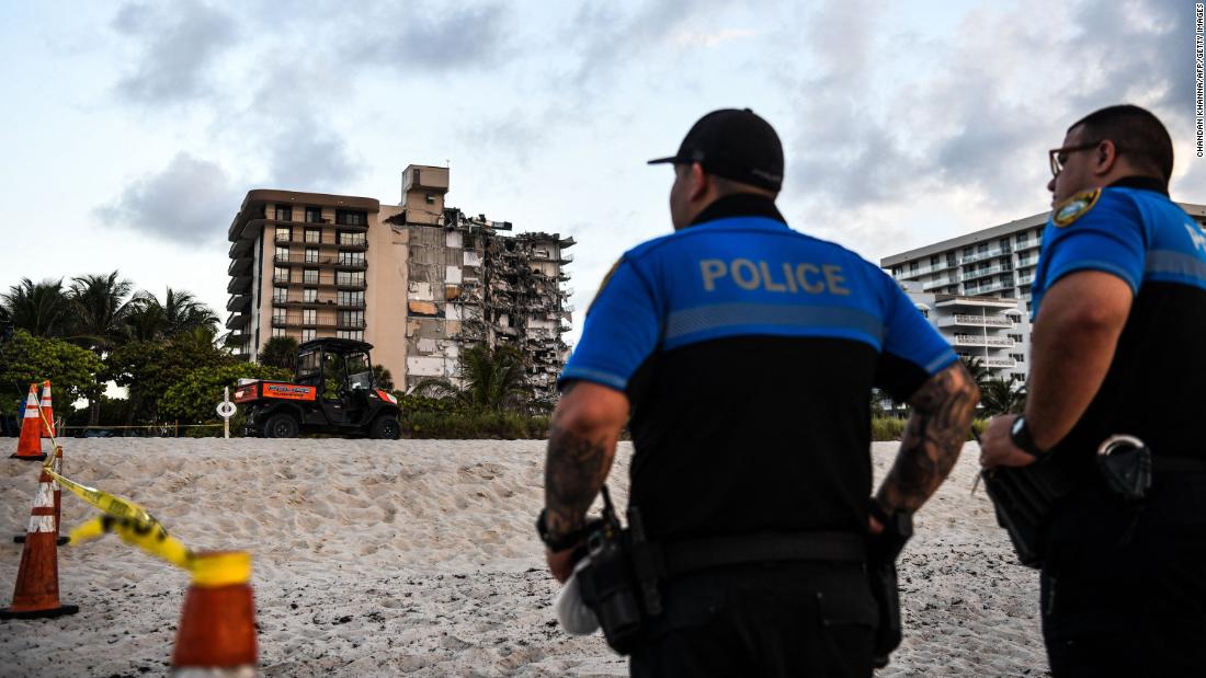 Police stand guard on the day the building collapsed.