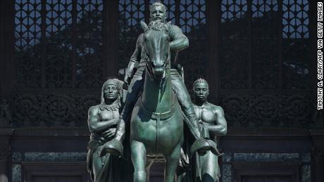 The Theodore Roosevelt Equestrian Statue, which sits in front of the The American Museum of Natural History, features Roosevelt on horseback towering over a Native American man and an African man.