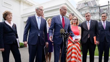 President Joe Biden, with a bipartisan group of senators, speaks Thursday June 24, 2021, outside the White House in Washington. Biden invited members of the group of 21 Republican and Democratic senators to discuss the infrastructure plan. 