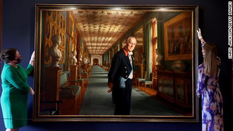 Curators adjust a portrait of Prince Philip by the artist Ralph Heimans in the Great Hall of Windsor Castle.