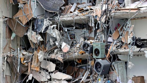 Debris dangles from the building on Thursday.