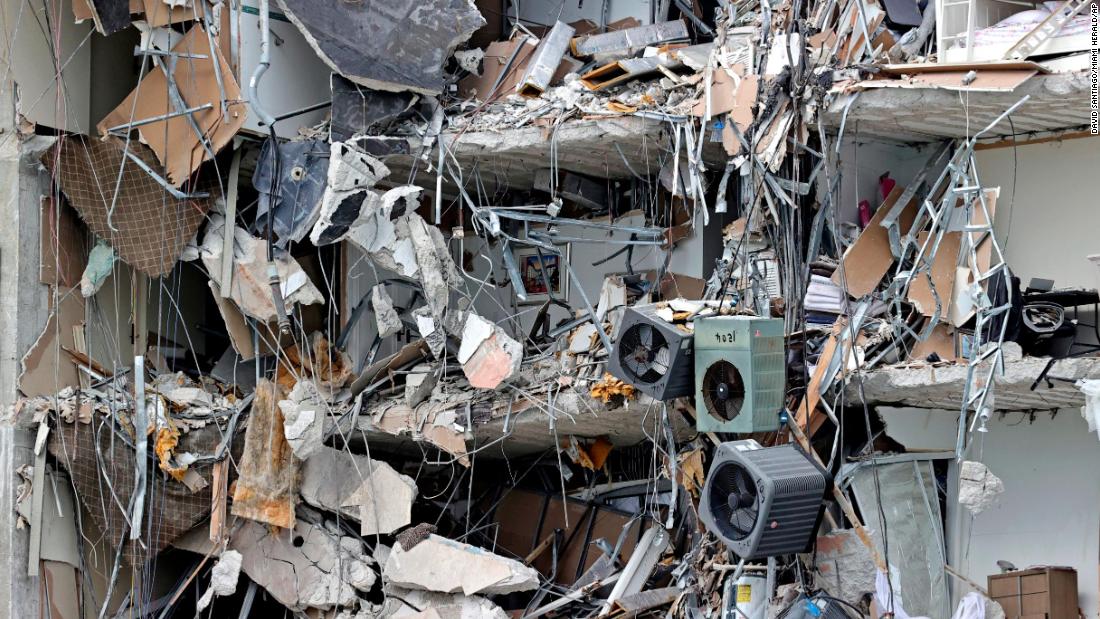 Debris dangles from the building on June 24.