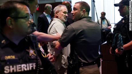 Jon Tigges is detained following a controversial Loudoun County School Board meeting in Ashburn, Virginia on Tuesday.