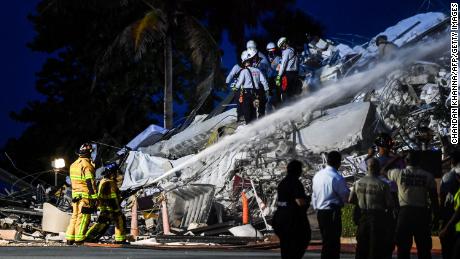 Search and Rescue personnel work at a partial collapse building in Surfside, Miami Beach, on June 24, 2021. - A high-rise oceanfront apartment block near Miami Beach partially collapsed early Thursday, killing at least one person and leaving 99 unaccounted for, with fears the toll may rise much higher as rescuers comb through the rubble. (Photo by CHANDAN KHANNA / AFP) (Photo by CHANDAN KHANNA/AFP via Getty Images)