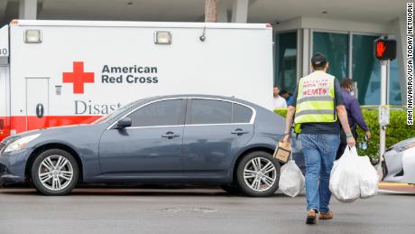 Jun 24, 2021; Miami, FL, USA;  EMT responders carry donations toward the town&#39;s community center to help people affected by the collapse of a building in Surfside, Florida. Mandatory Credit: Sam Navarro-USA TODAY NETWORK