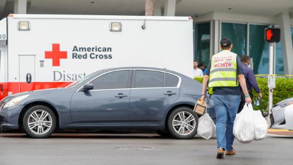 Jun 24, 2021; Miami, FL, USA; EMT responders carry donations toward the town's community center to help people affected by the collapse of a building in Surfside, Florida. Mandatory Credit: Sam Navarro-USA TODAY NETWORK