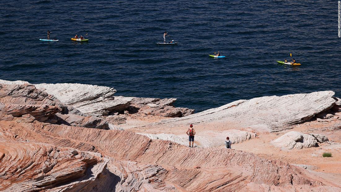 Kayakers navigate the waters of Lake Powell in Page, Arizona, on June 24.