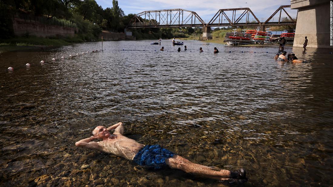 Gerry Huddleston cools off in the shallow water of the Russian River in Healdsburg, California, on June 16.
