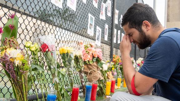 Leo Soto sets up a memorial site with photos of missing people from the complex. One of the missing people is his friend Nicole Langsfield.