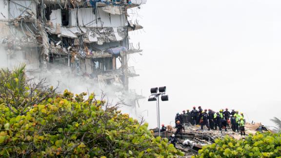 Rescue personnel search through the building's rubble on Friday.