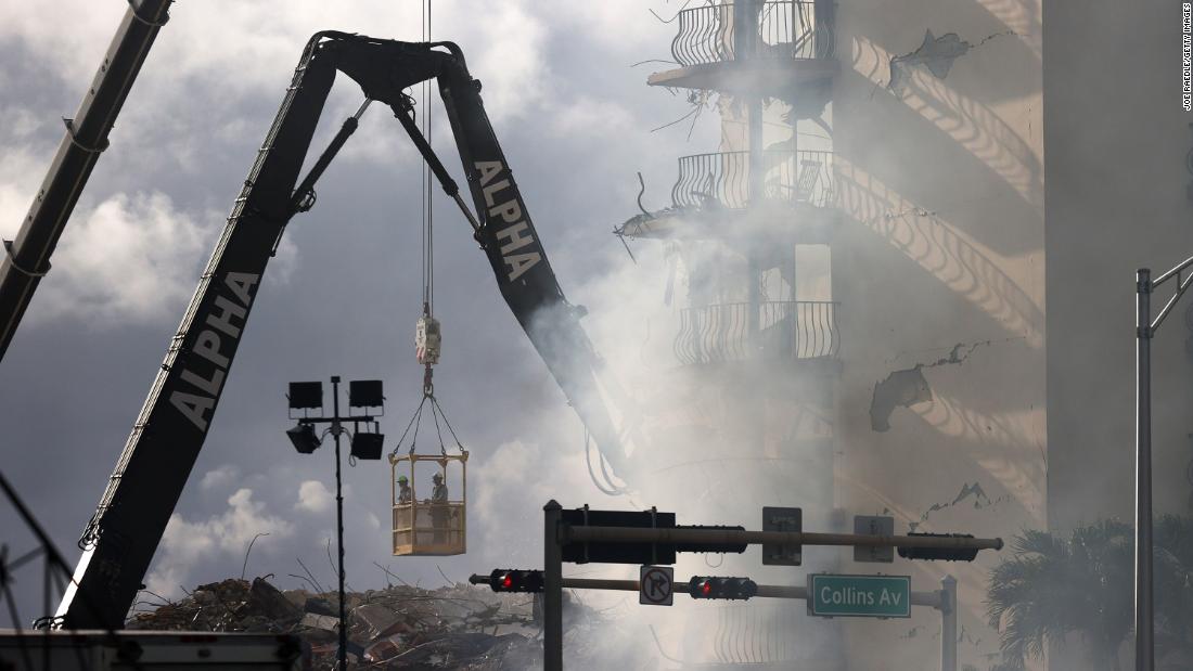 Smoke rises as rescuers continued to search for survivors on June 26.