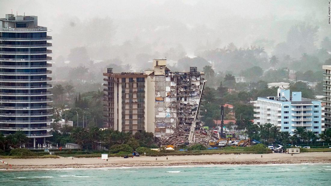 Workers search through the rubble on June 26.