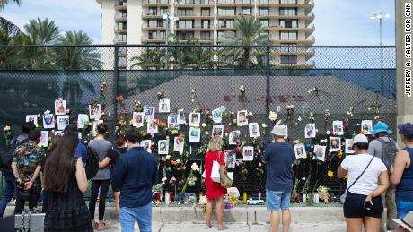 A memorial wall of photos for missing victims the site of the Champlain Towers South Condo building collapse in -Surfside, Florida.