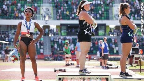 EUGENE, OREGON - JUNE 26: Gwendolyn Berry (L), third place, looks on during the playing of the national anthem with DeAnna Price (C), first place, and Brooke Andersen, second place, on the podium after the Women&#39;s Hammer Throw final on day nine of the 2020 U.S. Olympic Track &amp; Field Team Trials at Hayward Field on June 26, 2021 in Eugene, Oregon. (Photo by Patrick Smith/Getty Images)