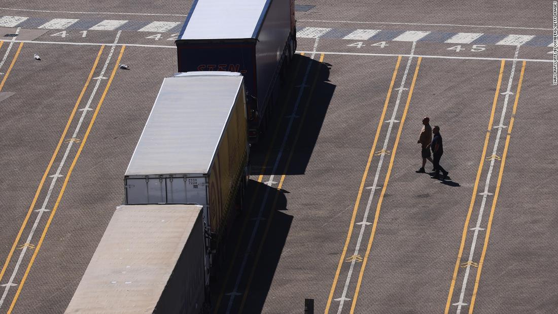 Truck drivers cross a haulage truck parking lot at the Port of Dover on June 1, 2021. Almost a third of UK logistics companies expect to face trucker shortages this year, and 10% say recruitment issues pose an "extreme barrier" to the recovery from the pandemic. 