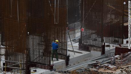 A migrant worker works at a building construction site on May 29, 2021 in Singapore. 