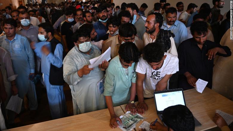 Desperate expatriate workers storm Islamabad vaccination center