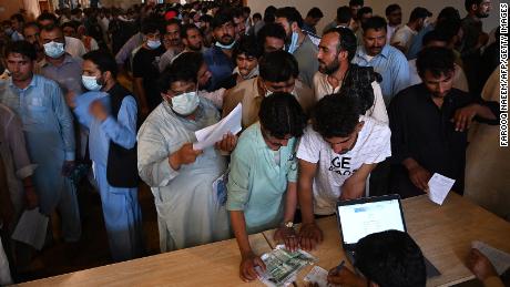 People including overseas Pakistani workers line up to register before for the Pfizer Covid-19 vaccine in Islamabad , Pakistan, on June 28.