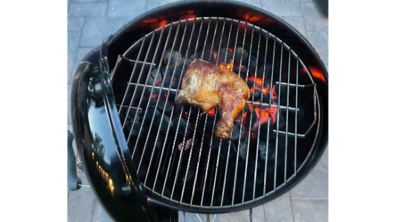 Chicken searing on a Weber charcoal grill.