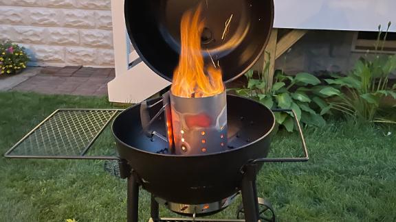 Rapidfire Chimney Starter inside a charcoal grill.