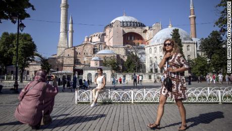 Des touristes prennent des photos devant la mosquée Sainte-Sophie à Istanbul, en Turquie, le 27 juin 2021. La réduction du tourisme pourrait entraîner une augmentation du chômage de 10 %, selon la CNUCED.