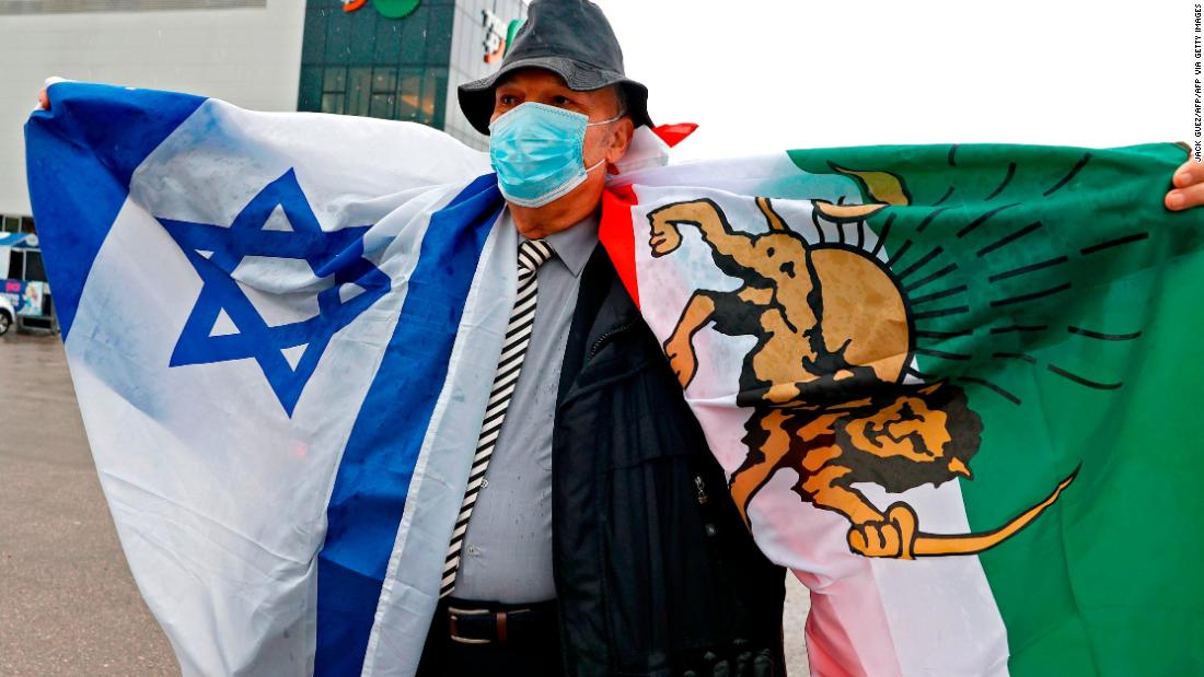 An Israeli man of Iranian descent holds Iran's pre-revolution flag in support of Iranian judoka Saeid Mollaei during the Tel Aviv Grand Slam 2021 on February 19, 2021.