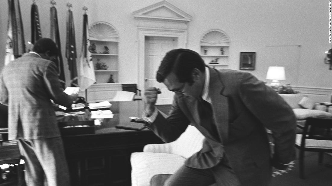 Rumsfeld pumps his fist while working in the White House Oval Office in 1974. Rumsfeld was White House chief of staff before becoming President Gerald Ford&#39;s secretary of defense in 1975.