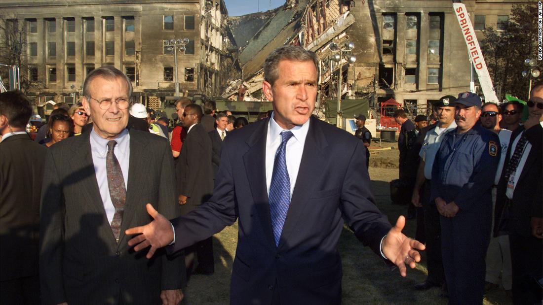 Rumsfeld, left, joins Bush as they visit the Pentagon following the terrorist attacks on September 11, 2001.