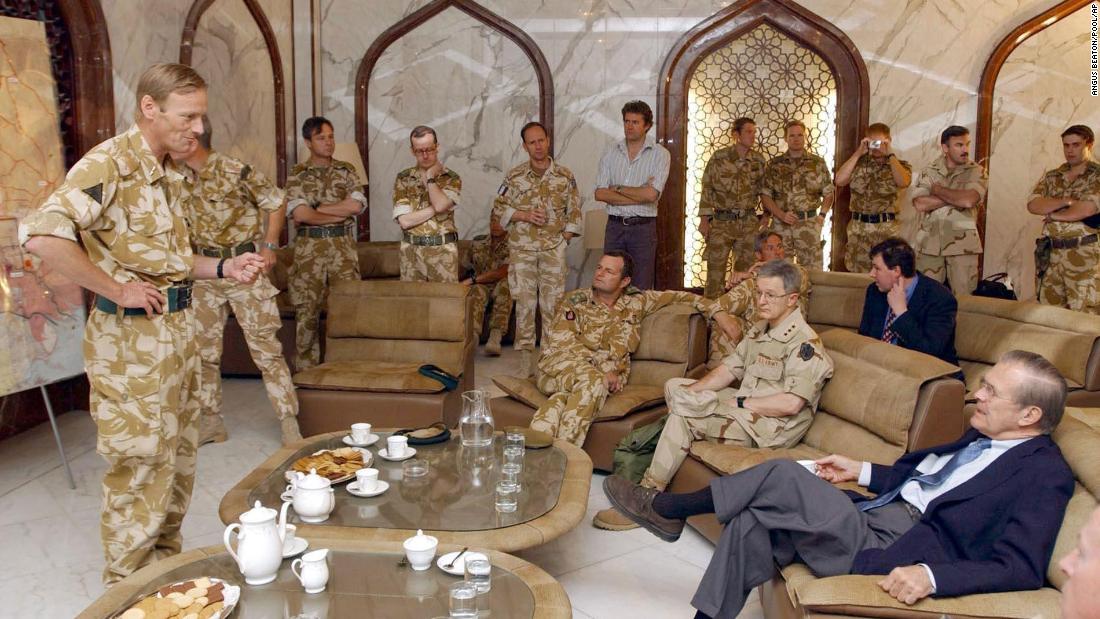 Rumsfeld is briefed by British Major Gen. Robin Brimms, left, at the Basra Airport in Iraq in April 2003.