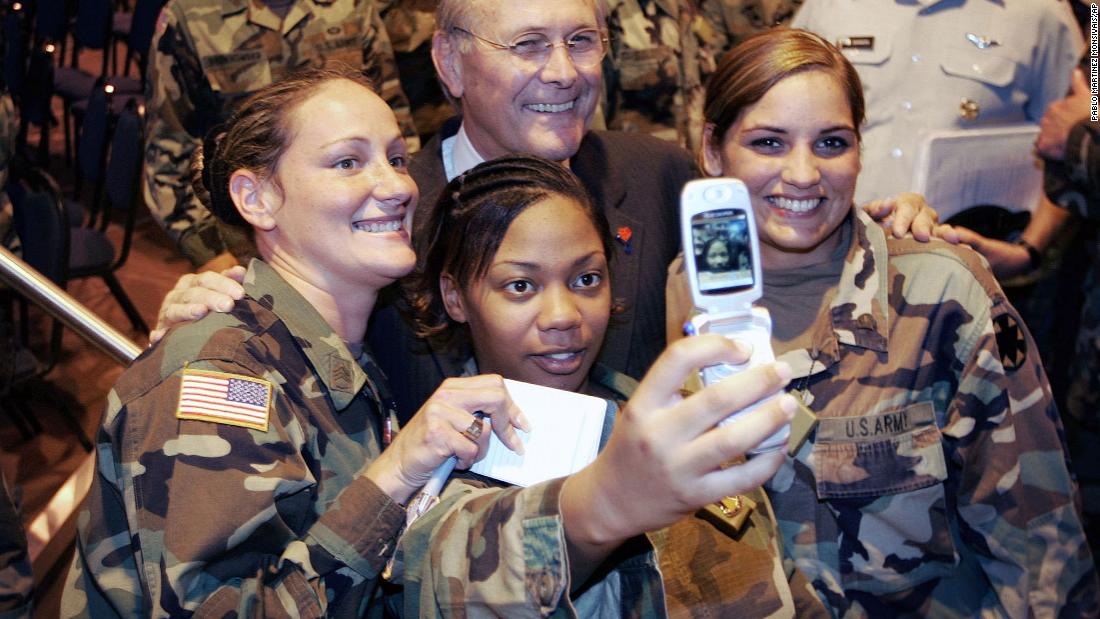 Rumsfeld poses for a photo with US troops during a visit to California&#39;s Fort Irwin in August 2005.