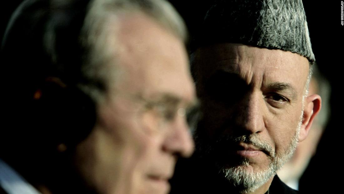 Rumsfeld holds a joint news conference with Afghan President Hamid Karzai in Kabul, Afghanistan, in December 2005. Rumsfeld told reporters that the United States was not going to abandon Afghanistan.