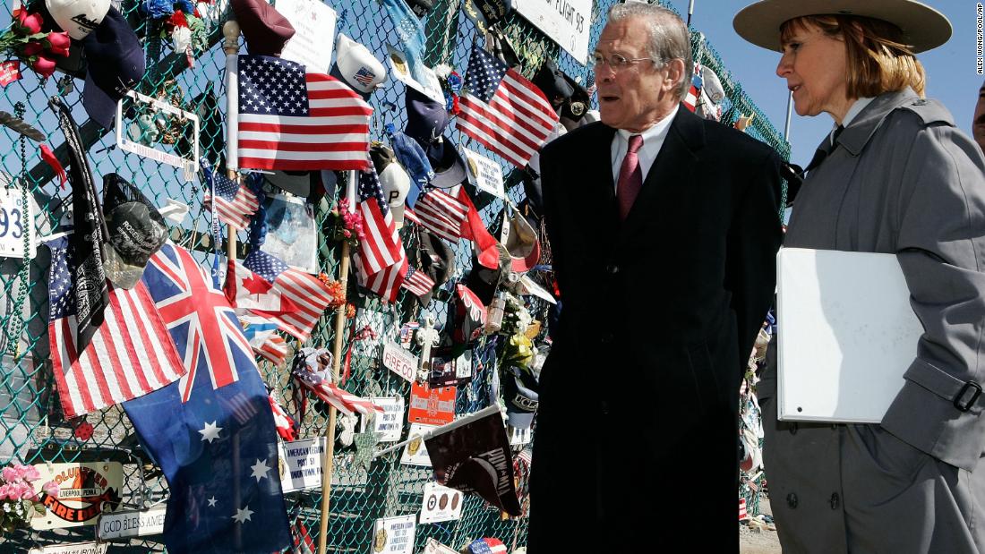 Rumsfeld is escorted by Joanna Hanley, superintendent of the Flight 93 Memorial, as he looks at tributes in Shanksville, Pennsylvania, in March 2006.