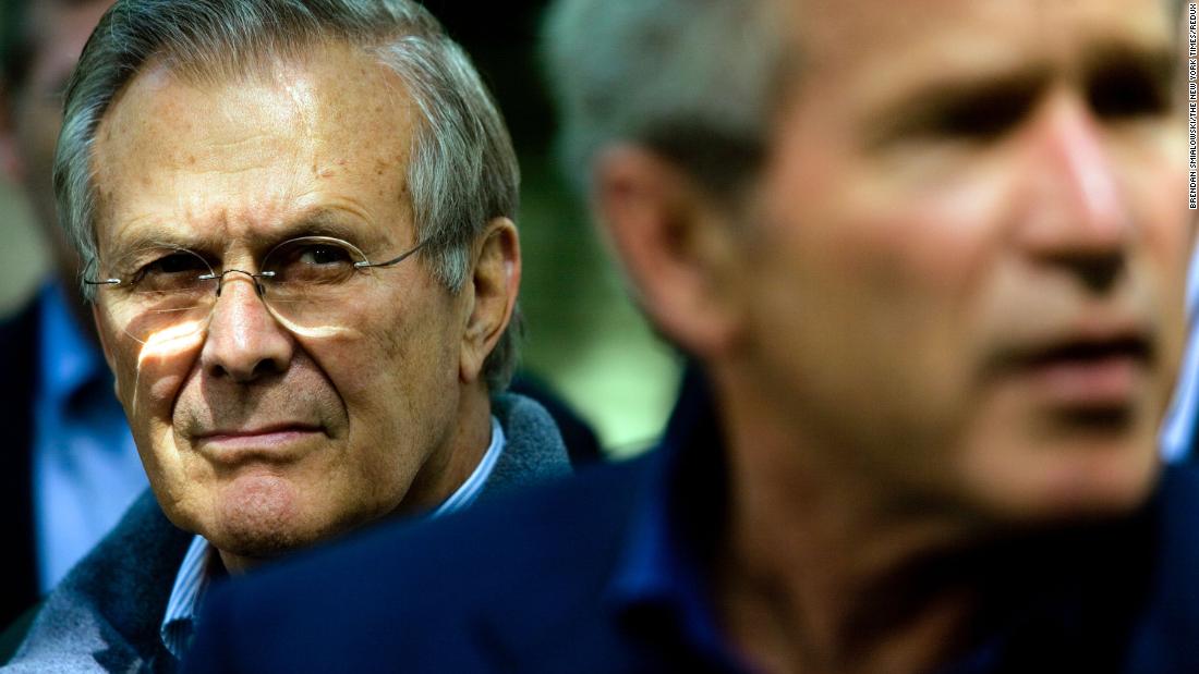 Rumsfeld listens as Bush speaks to reporters at Camp David, the presidential retreat in Maryland, in June 2006.